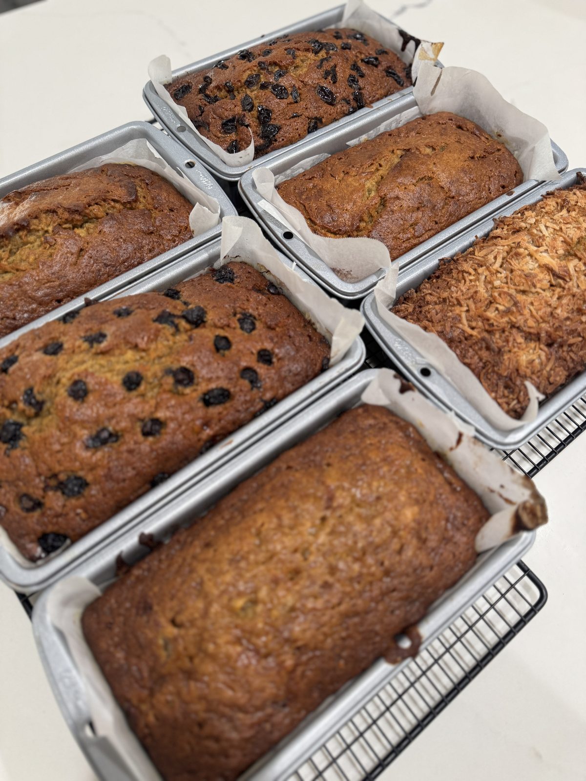 Chocolate chip banana bread loaf, sliced to show melted semisweet chocolate chips throughout