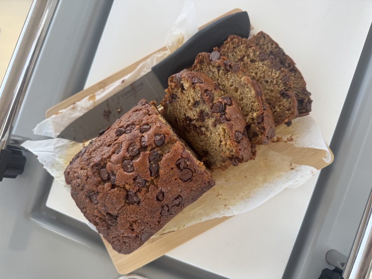 Multiple seasonal banana bread flavors lined up, including chocolate chip, coconut butterscotch, and classic